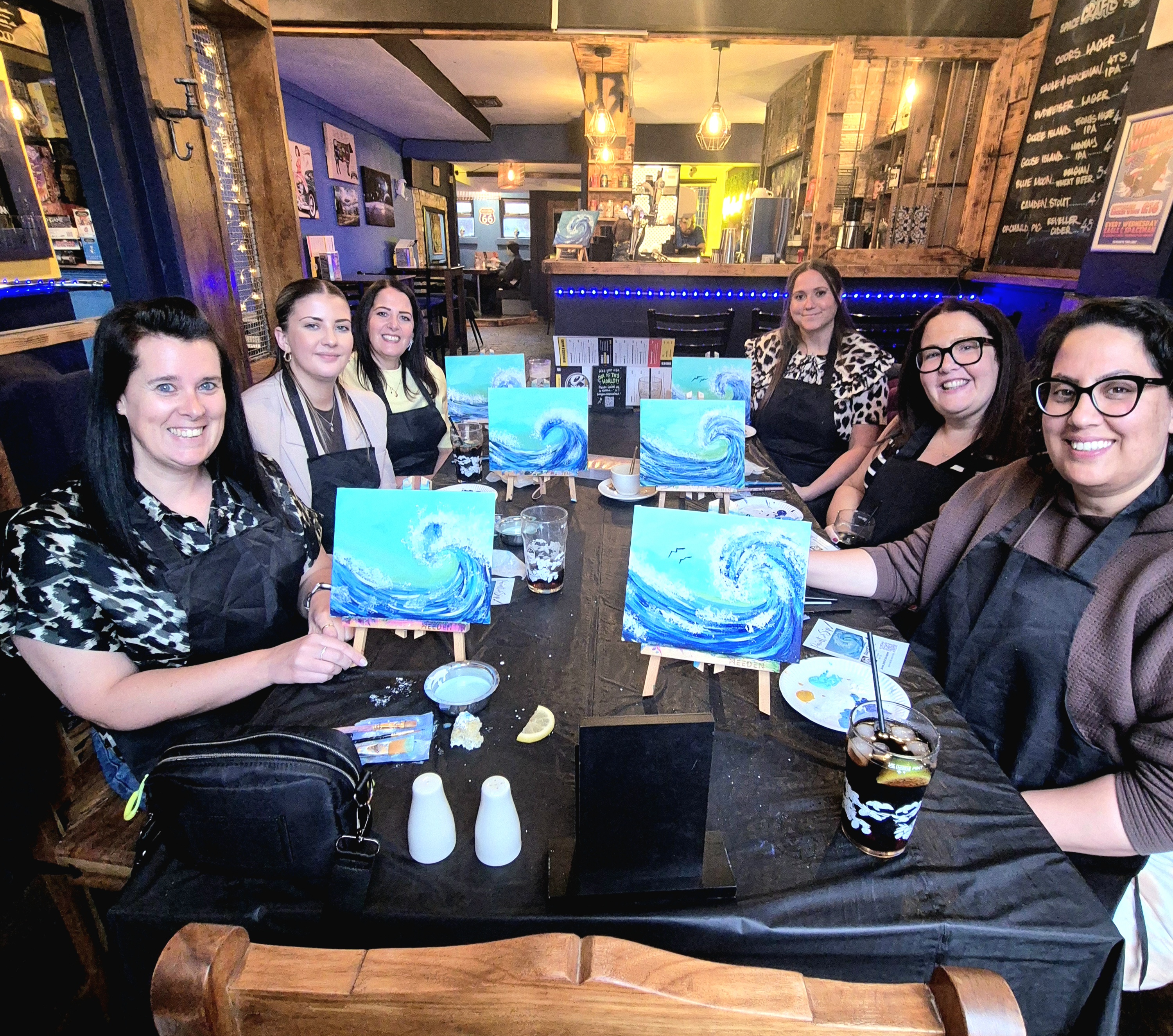 Group of customers holding their paintings